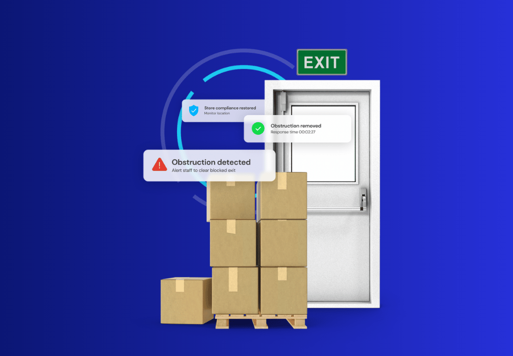 Image of fire exit door on a blue background, the fire exit is obstructed with boxes and has notifications from SeeChange advising blockage detected